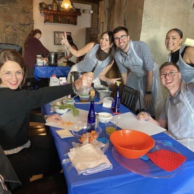 Participants happily preparing ingredients during a Wicked Good Chowda Cook-Off team building event.