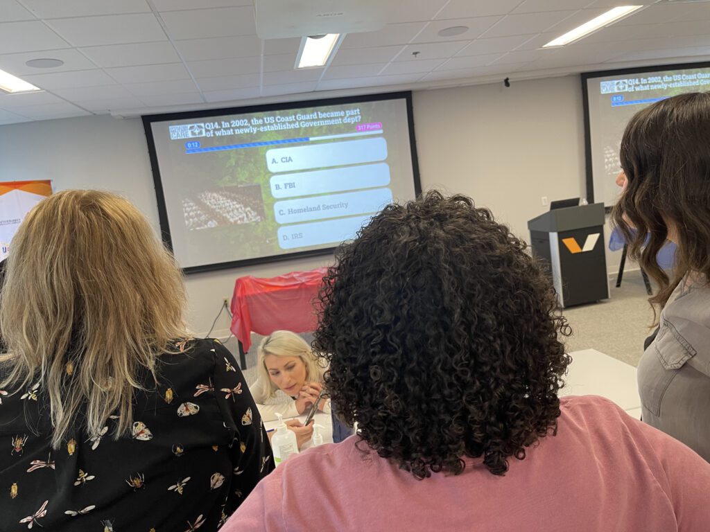 Participants engage in a trivia session as part of the Operation Military Care team building event, testing their knowledge on U.S. military history and organizations.