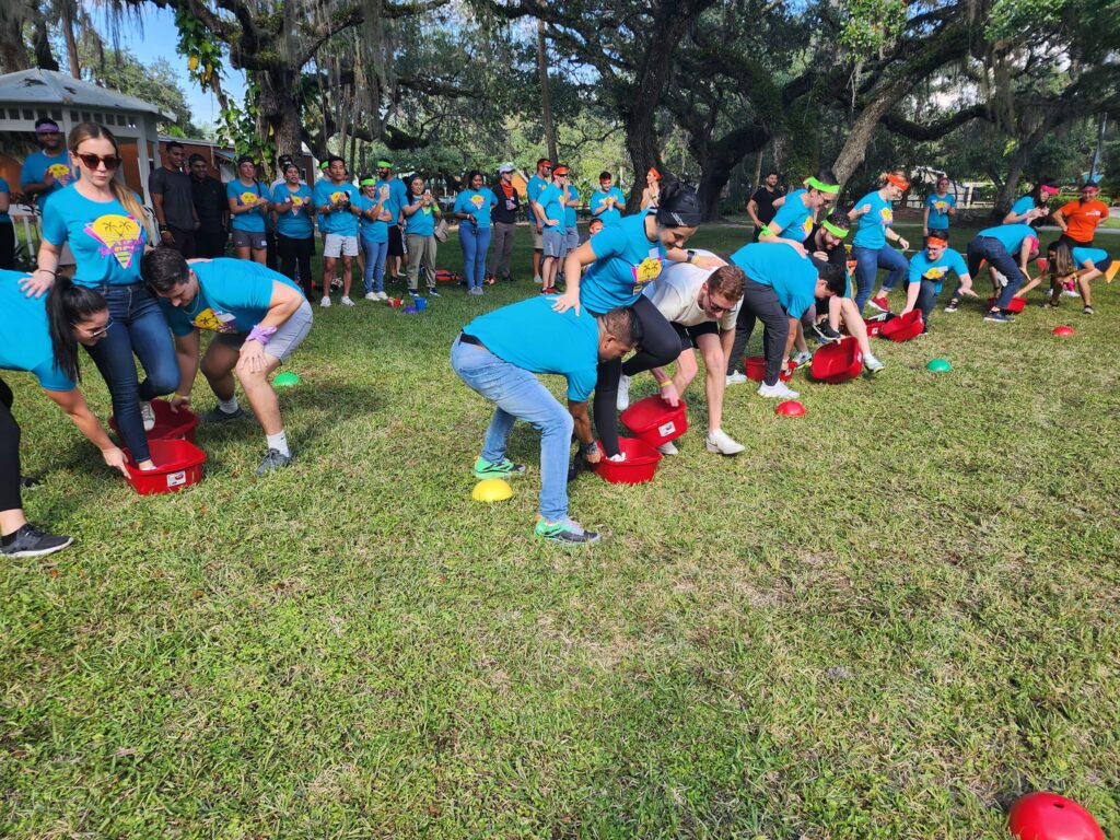 Teams compete in a fun and engaging relay race during the Outrageous Games team building event, fostering collaboration and energy.