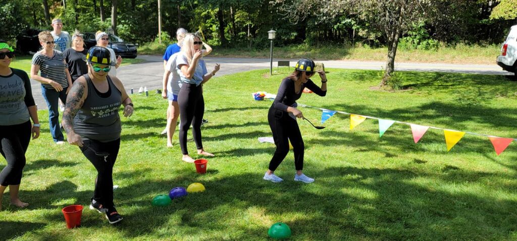 Participants engaged in a fun relay challenge during the Outrageous Games team building event, promoting teamwork and friendly competition.