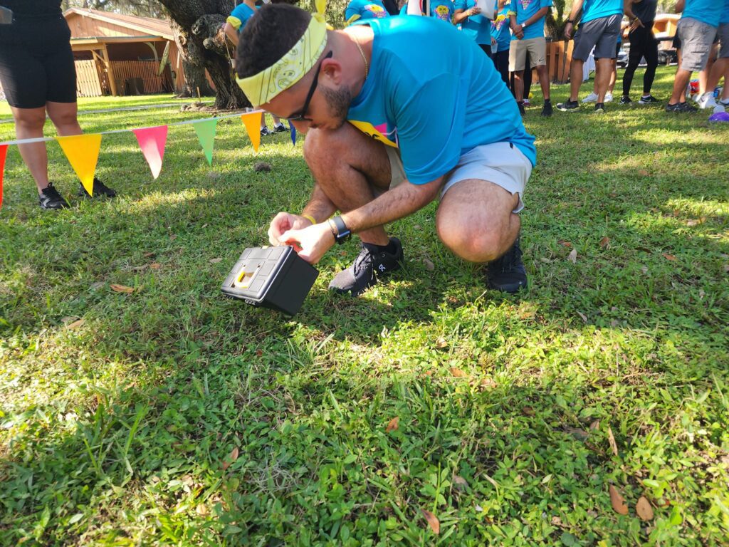 A team member solves a puzzle during the Outrageous Games team building event, fostering problem-solving and collaboration.