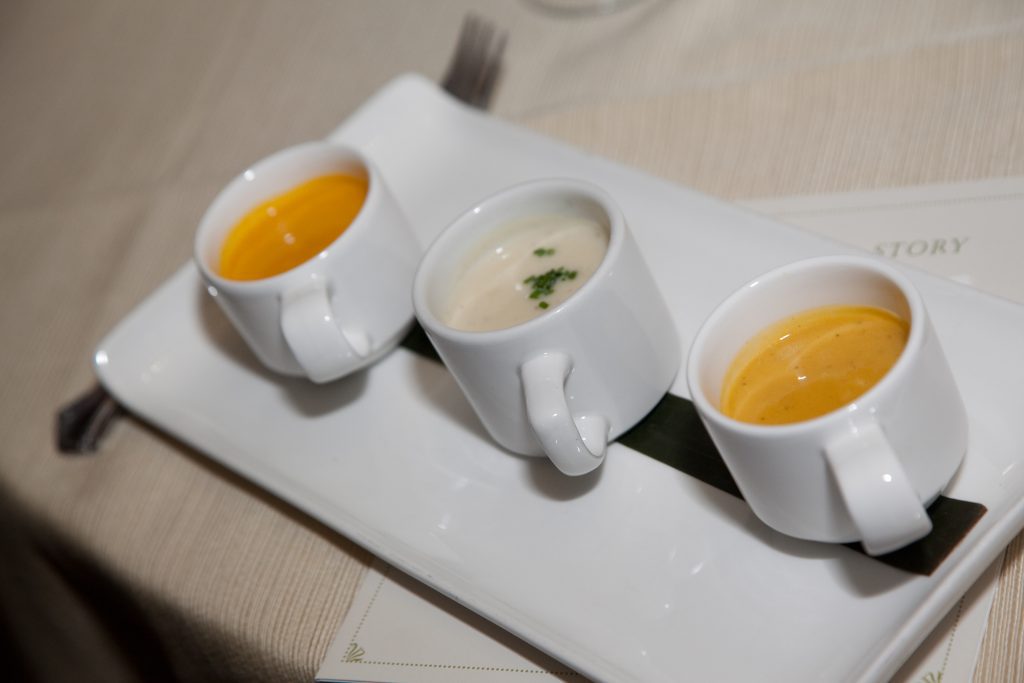 A selection of three different soups presented in small cups as part of the Dining in the Dark experience, highlighting the sensory nature of the event.