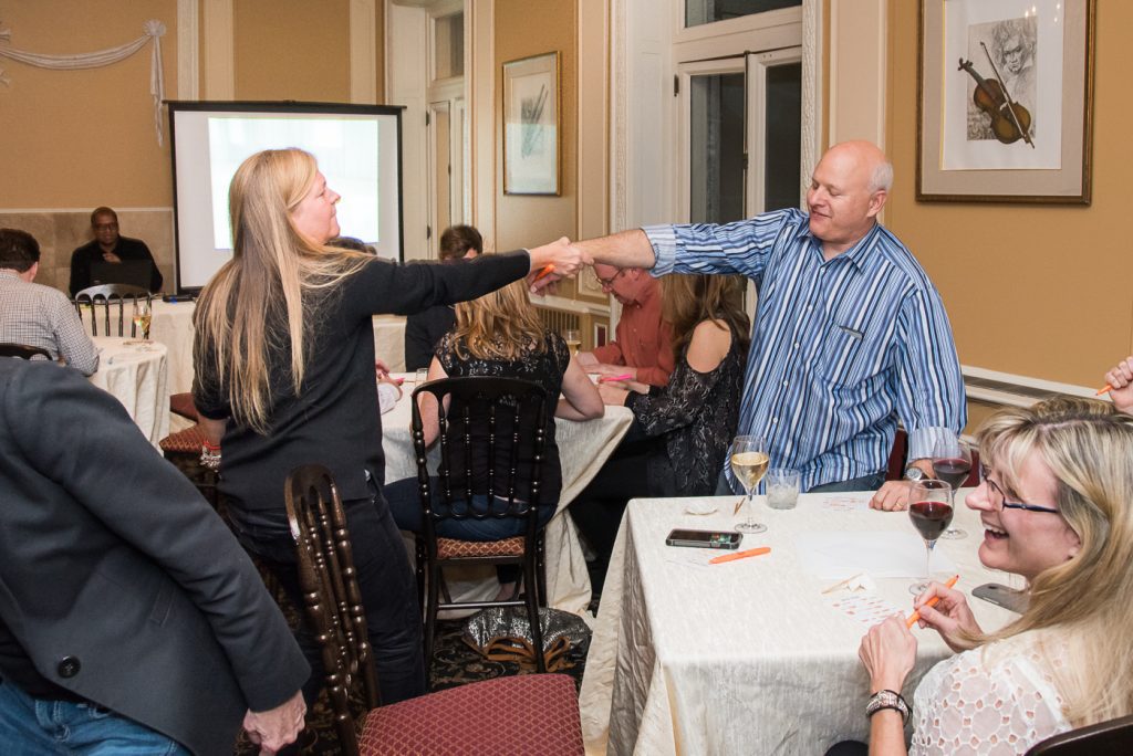 Participants completing a challenge during a Wild Card Team Building Bingo event.