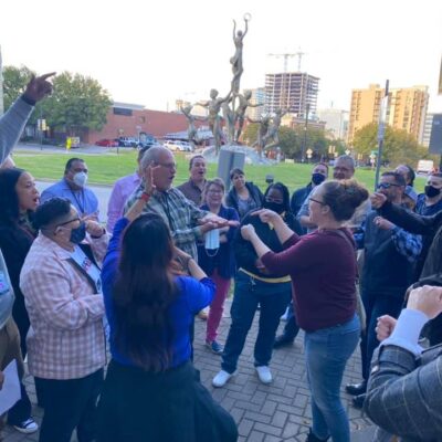 Participants energetically engaging in an outdoor challenge during the Pub Crawl Scavenger Hunt, fostering team spirit and connection in a lively city setting.