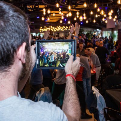 A participant is capturing the high-energy atmosphere of the team as they engage in challenges, showcasing both excitement and collaboration during this fast-paced team building experience.