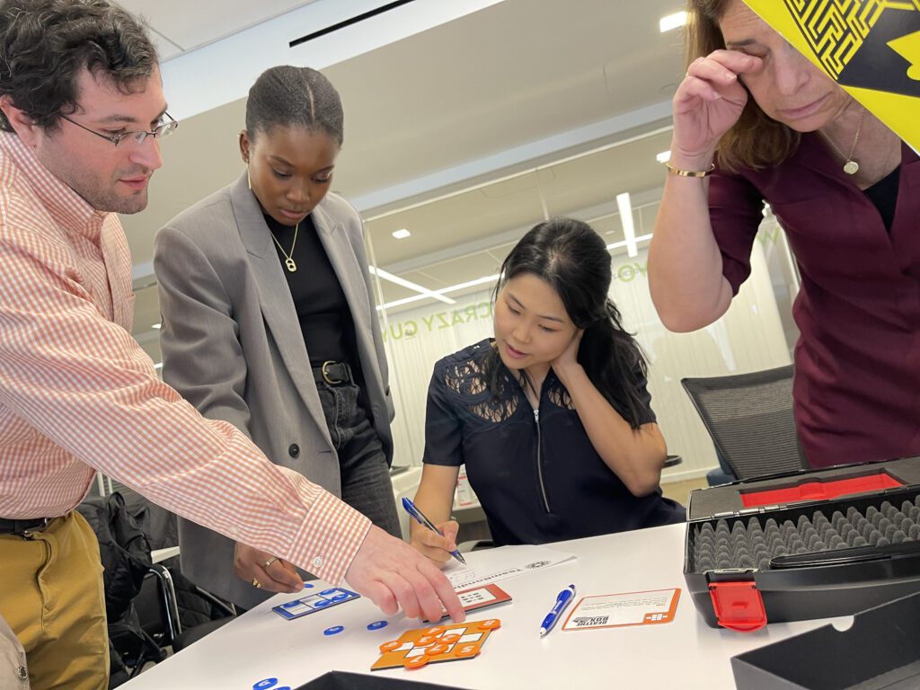 Team collaborating closely to solve puzzles during the Beat The Box team building event, focused on unlocking the next challenge.