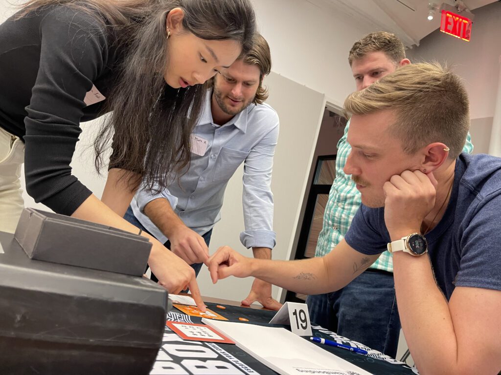 Focused team members work together to solve a puzzle during the high-energy Beat The Box team building event, showcasing their problem-solving skills and collaboration.