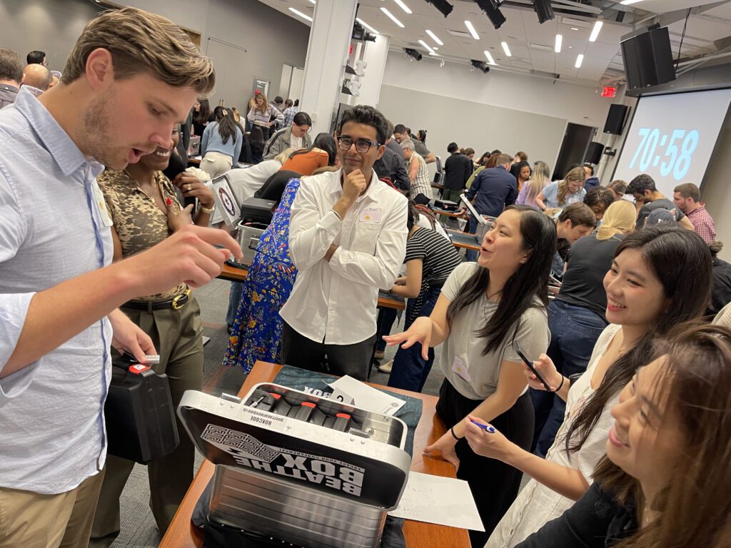 Enthusiastic participants engage in solving complex puzzles during the Beat The Box team building event, working against the clock to unlock clues and achieve success together.