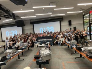 Large group of participants proudly posing after successfully completing the Beat The Box team building event, celebrating their collaborative effort and teamwork.