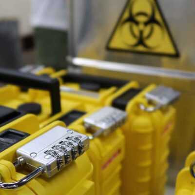 Yellow lockboxes with combination locks and biohazard symbols used in the 'Atmosphere' team building event.