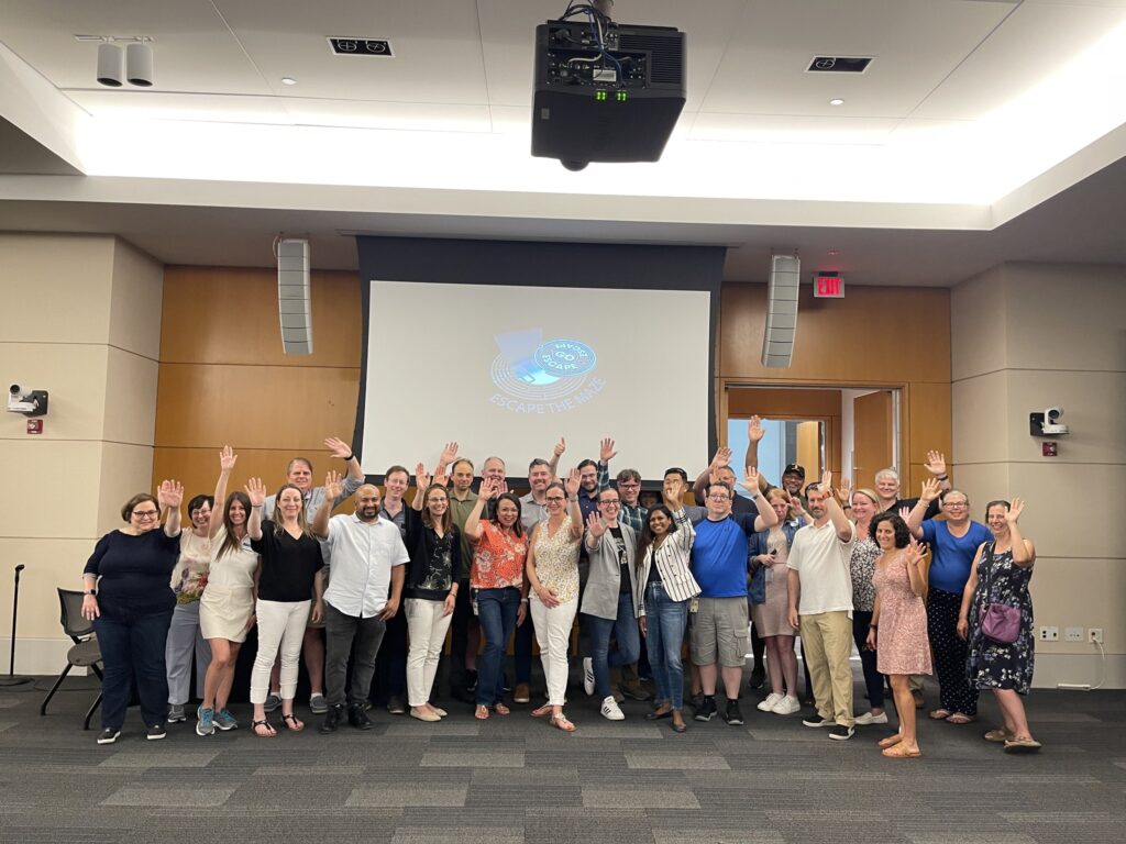 Group photo of participants celebrating after completing the 'Escape The Maze' team building activity, fostering teamwork and accomplishment.