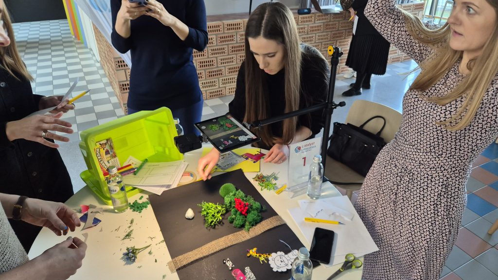 Stop motion animation team building activity. Participants collaborate to create a short film using props and careful frame-by-frame adjustments, emphasizing creativity, teamwork, and communication.