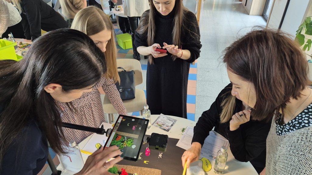 Team building activity centered on stop motion animation. Participants work together to position props and capture frames, fostering creativity, collaboration, and effective communication in storytelling.