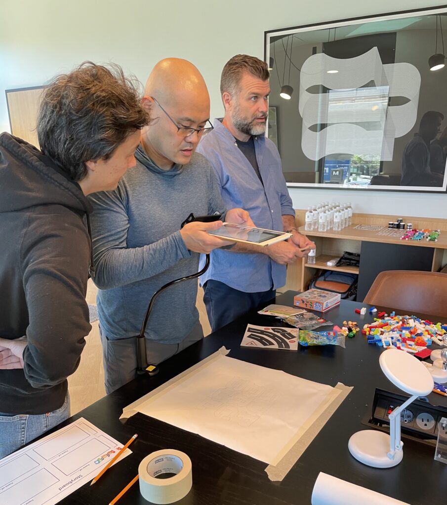 Participants reviewing animation sequences on a tablet during a stop motion animation team building activity, fostering collaboration and creativity.