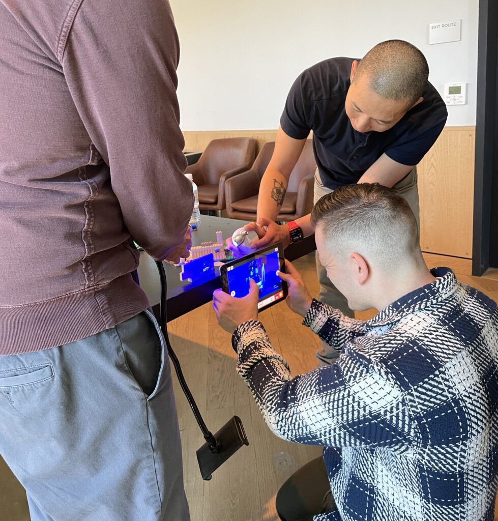 Team members capturing footage for a stop motion animation film during a hands-on team building event.