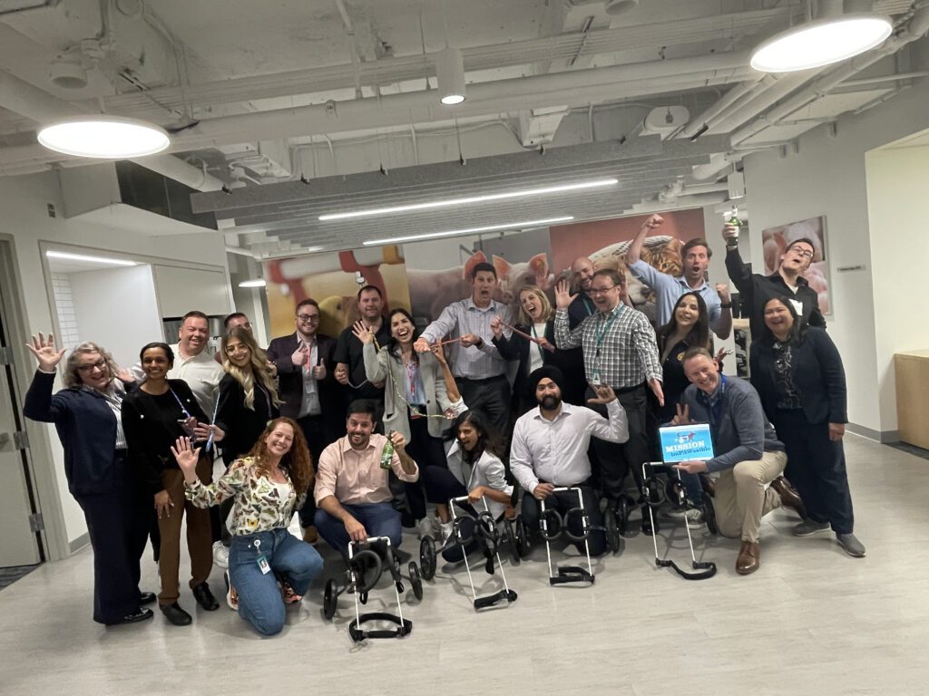 A group of participants proudly showcasing their completed pet wheelchairs after a successful 