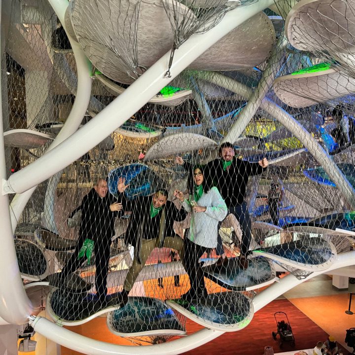 Team participating in a museum scavenger hunt, exploring an interactive climbing exhibit. This team building activity combines culture, problem-solving, and adventure in a fun and engaging experience.