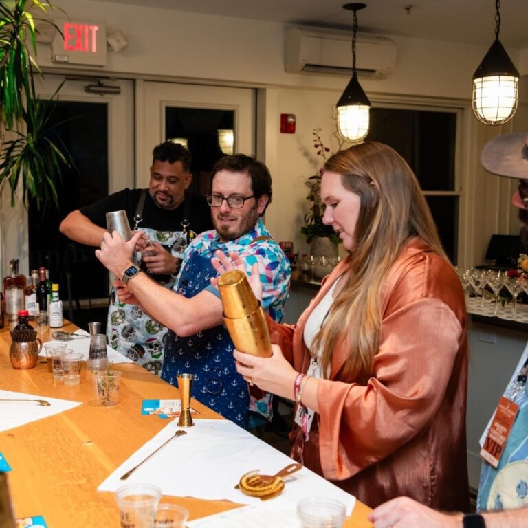 Team members shaking up cocktails during a mixology class. This fun and interactive team building event encourages collaboration, creativity, and the art of crafting delicious drinks.